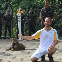 Fisioterapis Brasil Igor Simoes Andrade berpose bersama Juma si jaguar dalam upacara Obor Olimpiade di Manaus, 20 Juni 2016 (foto: reuters)