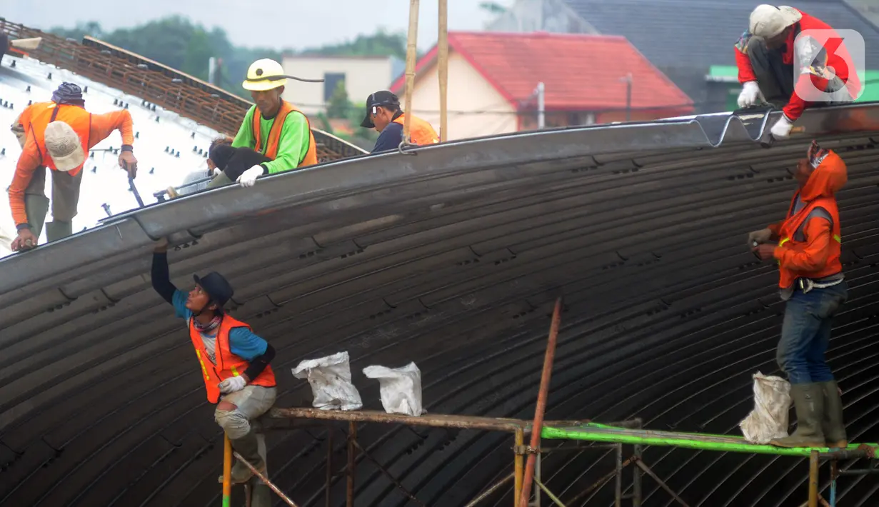 Pekerja memasang baja konstruksi saat pembangunan Flyover Gaplek di Jalan Martadinata,  Pamulang, Tangerang Selatan, Minggu (1/3/2020). Pembangunan flyover yang akan menghubungkan Parung, Jawa Barat, dengan DKI Jakarta tersebut saat ini sudah mencapai 40 persen. (merdeka.com/Arie Basuki)