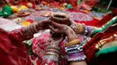 Wanita Hindu yang sudah menikah melakukan ritual festival Karva Chauth di Ahmadabad,  Kamis (17/10/2019). Selama festival Karva Chauth, wanita-wanita yang sudah menikah di India berpuasa sepanjang hari dan memohon umur panjang serta keselamatan untuk suami mereka. (AP/Ajit Solanki)