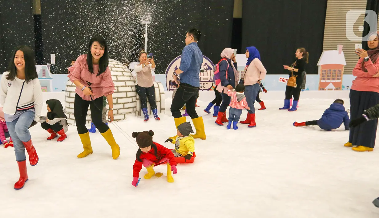 Pengunjung bermain wahana salju pada ICEFEST 2019 di BSD Tangerang, Kamis (19/12/2019). ICEFEST 2019 hadir mengangkat kisah persahabatan ILO dan Aiden di desa Happy Village yang diharap dapat memberikan edukasi yang dikemas dengan hiburan kepada anak-anak. (Liputan6.com/Fery Pradolo)