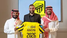 Penyerang asal Prancis, Karim Benzema memegang kaus klub Al-Ittihad Arab Saudi saat ia berpose untuk foto diapit oleh anggota Al-Ittihad, di Madrid pada 6 Juni 2023. (AFP/Liga Pro Saudi/jorge ferrari)