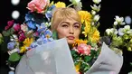Top model Gigi Hadid mengenakan rancangan rumah mode Moschino saat Milan Fashion Week di Italia, Kamis (21/9). Dalam catwalknya Gigi Hadid mengenakan atribut penuh bunga di tubuhnya. (AFP Photo/Marco Bertorello)