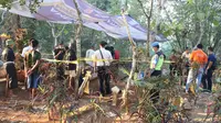 Personel Polres Kebumen dan tim dokter RSUD Margono Sukarjo membongkar makam untuk mengotopsi jenazah diduga korban pembunuhan.  (Foto: Liputan6.com/Muhamad Ridlo)