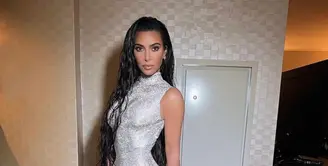 Sementara Kim Kardashian tampil glamor dalam balutan gaun sleeveless bodycon dress warna silver yang berkilauan dari Balenciaga. (Instagram/kimkardashian).
 