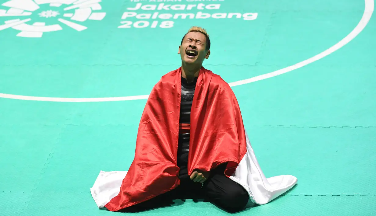 Ekspresi pesilat Indonesia, Hanifah Yudani Kusumah usai mengalahkan Thai Linh Nguyen asal Vietnam dalam babak final Kelas C Putra Asian Games 2018 di Padepokan Pencak Silat TMII, Jakarta, Rabu (29/8). (ANTARA FOTO/INASGOC/Melvinas Priananda/nak/18)