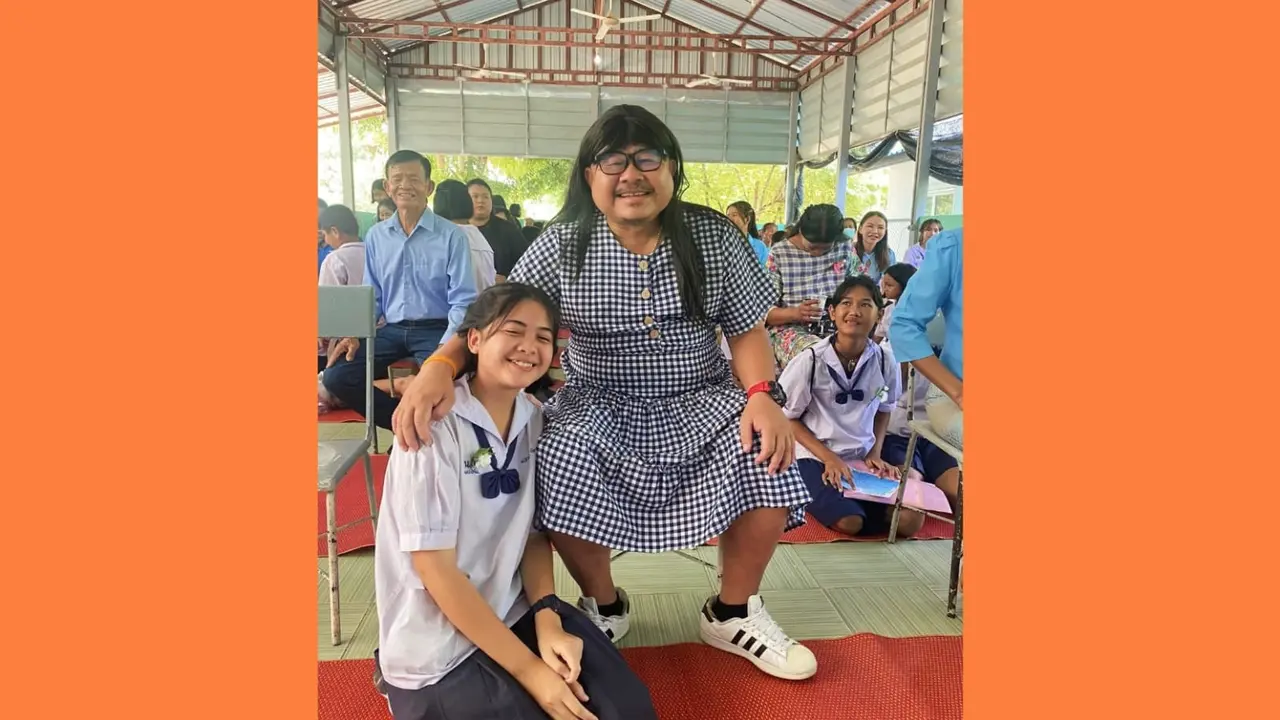 Prachya Deebu, seorang ayah tunggal asal Thailand yang mengunjungi sekolah putrinya, berdandan seperti wanita dengan mengenakan gaun.