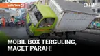 Sebuah mobil box terguling di Jalan Raya Rawa Buaya, Cengkareng, Jakarta Barat, Kamis siang, setelah kondisi jalan menjadi licin usai diguyur hujan.
