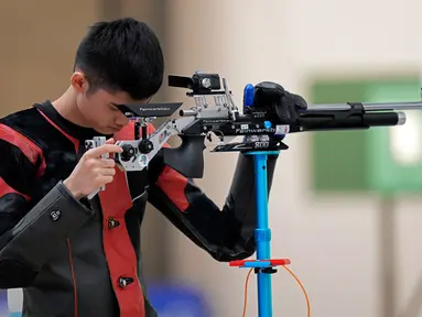 Sheng Lihao dari China berhenti sejenak saat berkompetisi dalam kualifikasi senapan angin 10 meter putra Asian Games 2023 di Fuyang Yinhu Sports Center, Hangzhou, China, Senin (25/9/2023). Sheng Lihao mencetak rekor dunia dengan mendulang 253,3 poin, di mana angka setinggi ini belum pernah ada yang mencatatkannya di nomor tersebut. (AP Photo/Aijaz Rahi)