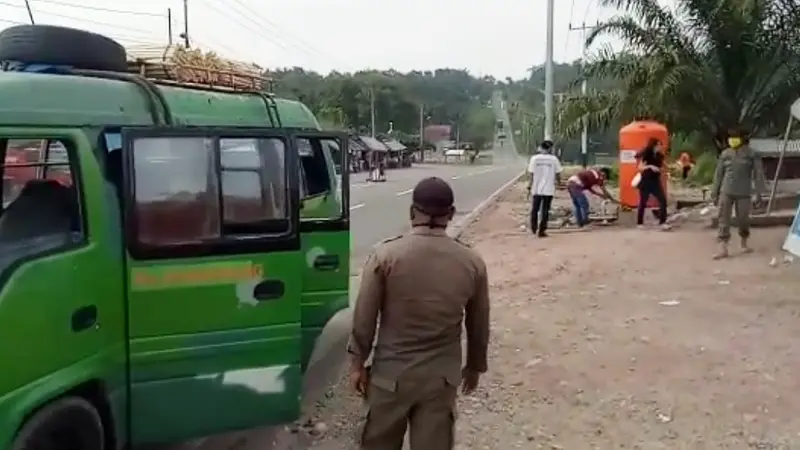 Petugas menghentikan kendaraan yang melintas di perbatasan provinsi.