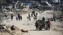Setelah kesepakatan gencatan senjata antara Israel dan Hamas resmi berlaku, puluhan ribu pengungsi Palestina mulai kembali ke Jalur Gaza, baik ke utara maupun selatan. (Eyad BABA/AFP)