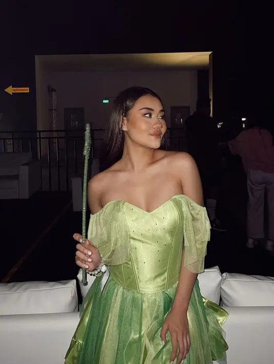 Aaliyah pernah cosplay menjadi Tinkerbell terlihat dari dress serba hijau dan aksesori yang ia kenakan. Ia mengenakan mini dress off shoulder bergaya bustier. [@aaliya.massaid]