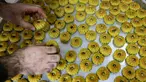 Seorang tukang roti Palestina meletakkan "maamoul" segar, kue tradisional berisi kurma atau kacang, di atas nampan pada malam Idul Fitri di akhir bulan suci Ramadhan, di Yerusalem, Kamis (20/4/2023). (Photo by AHMAD GHARABLI / AFP)