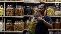 Pedagang memasukan kue kering di Pasar Mayestik, Jakarta Selatan, Senin (11/6). Separuh Ramadan dan jelang lebaran masyarakat mulai berburu kue kering. (Liputan6.com/Johan Tallo)