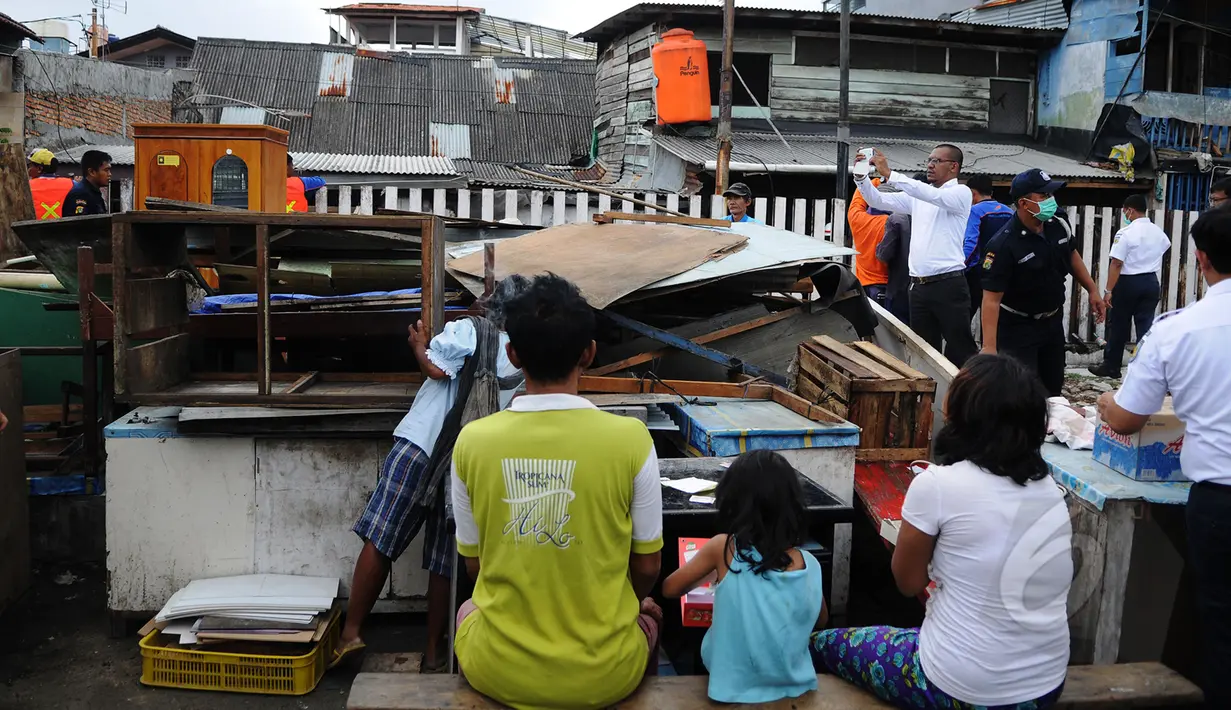 Warga mengevakuasi barang miliknya saat penggusuran di Stasiun Kemayoran, Jakarta, Senin (9/3/2015). Pembongkaran sembilan rumah warga yang masih berdiri di kawasan Stasiun kemayoran dilakukan oleh tim gabungan PT KAI. (Liputan6.com/Faizal Fanani)
