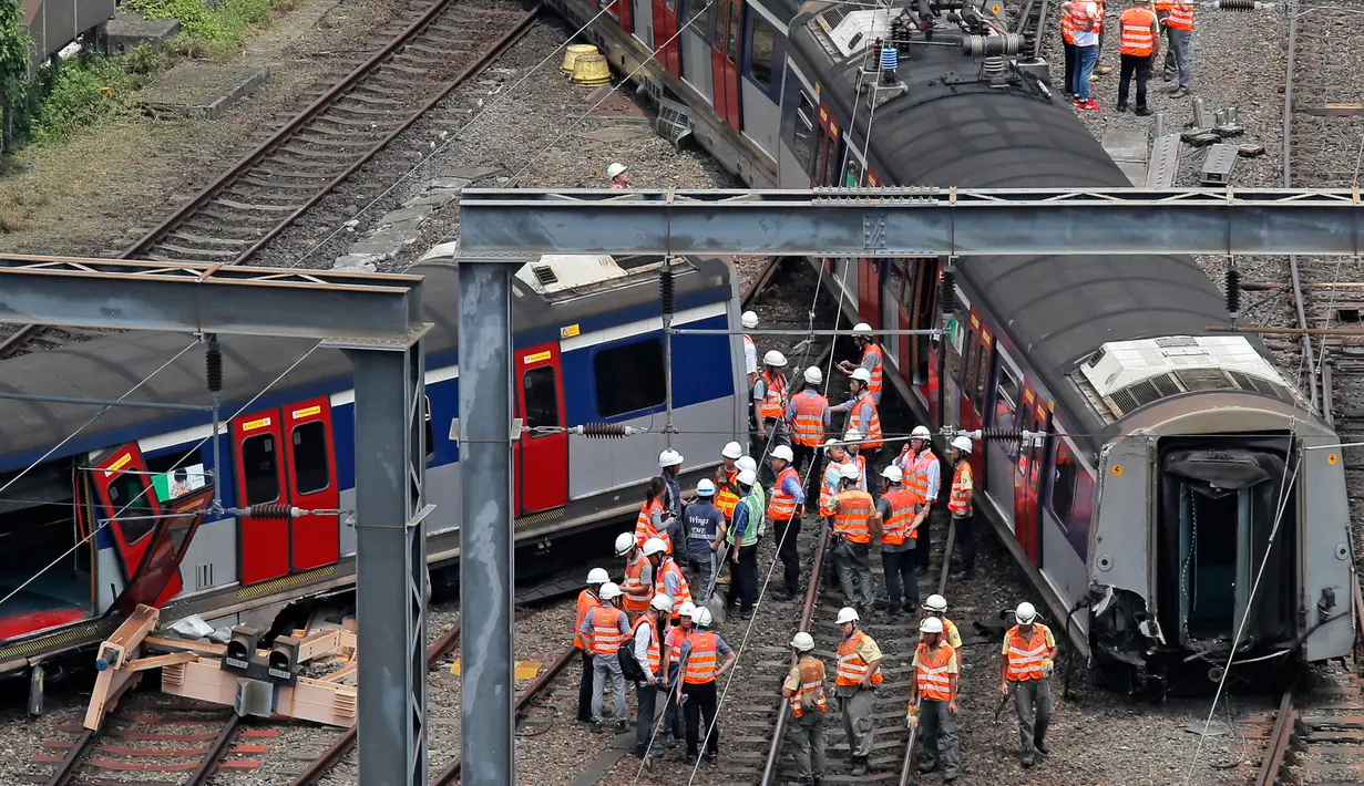 Regu penyelamat berada di lokasi tergelincirnya kereta metro atau Mass Transit Railway (MTR) di Stasiun Hung Hom, Hong Kong, Selasa (17/9/2019). Di lokas kejadian terlihat tiga gerbong keluar dari rel dan secara zig-zag melintasi jalur. (AP Photo/Kin Cheung)