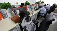 Sejumlah pegawai saat tidur siang di mejanya masing-masing pada jam istirahat di kantornya, di Beijing, China, (21/4). Kegiatan tidur siang ini pemandangan biasa di kalangan pekerja kantoran di China. (REUTERS / Jason Lee)