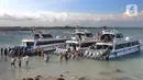 <p>Wisatawan antre naik ke kapal boat menuju kawasan wisata Nusa penida dan Nusa lembongan di Pelabuhan Sanur, Denpasar, Bali, Senin (2/5/20222). Lebih dari seribu wisatawan tiap harinya melakukan perjalanan wisata pulang pergi. (merdeka.com/Arie Basuki)</p>