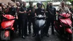 Menristekdikti Mohammad Nasir berpose di atas Motor listrik bernama Garansindo Electric Scooter ITS (GESITS) di Jakarta, Senin (7/11). GESITS adalah hasil kerjasama Garansindo dengan Institut Teknologi Sepuluh November (ITS). (Liputan6.com/Helmi Afandi)