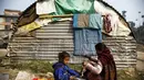 Seorang gadis membaca buku bersama ibunya di penampungan sementara setelah gempa bumi di Nepal, Jum'at (29/1/2016). Gempa bumi  pada bulan April dan Mei 2015 silam menewaskan  hampir 9.000 orang dalam bencana alam terburuk Nepal (Reuters/Navesh Chitrakar)