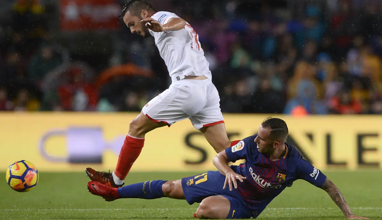 Pemain Barcelona, Paco Alcacer (kanan) jatuh saat berebut bola dengan pemain Seviilla, Pablo Sarabia pada lanjutan La Liga Santander di Camp Nou stadium, Barcelona, (4/11/2017). Barcelona menang 2-1. (AFP/Josep Lago)
