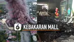 Di antara puing-puing hangus, sebuah patung maskot cepat saji Jollibee tampak masih utuh.