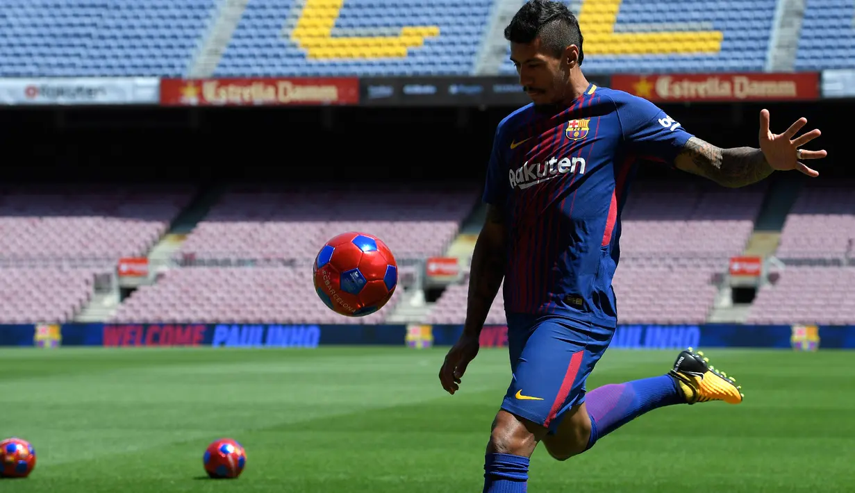 Pemain Baru Barcelona, Paulinho beraksi saat perkenalan dirinya di Stadion Nou Camp, Barcelona, (17/8). Paulinho meneken kontrak empat musim di Camp Nou. (AFP Photo/Lluis Gene)