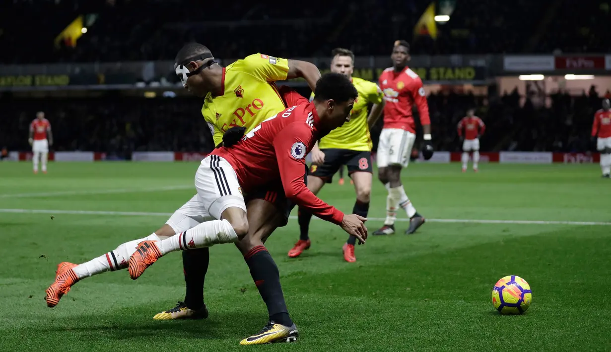 Pemain Watford, Marvin Zeegelaar berebut bola dengan pemain Manchester United, Jesse Lingard pada laga pekan ke-14 Premier League 2017-2018 di Vicarage Arena, Selasa (28/11). MU mengatasi perlawanan tuan rumah Watford dengan skor 4-2. (AP/Matt Dunham)