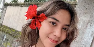Adinda Thomas, bintang film KKN yang dikenal hobi naik gunung juga gemar tampil dengan riasan natural alias flawless makeup. Dengan hiasan bunga saja, sudah cantik maksimal ya! (Foto: Instagram @adindathomas)