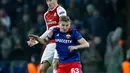 Pemain Arsenal, Laurent Koscielny melompat untuk merebut bola dari pemain CSKA Moscow, Fedor Chalov pada laga leg kedua perempat final Liga Europa di VEB Arena, Jumat (13/4). Arsenal hanya mampu bermain imbang dengan skor 2-2. (AP/Pavel Golovkin)