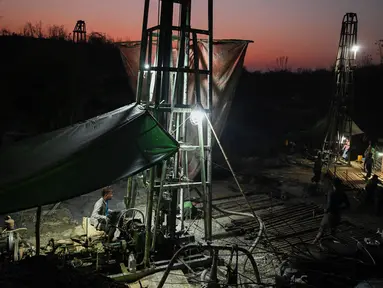 Pekerja mengoperasikan mesin saat melakukan pengeboran di sumur minyak ilegal di Minhla, Myanmar, 10 Maret 2019. Pengebor ilegal di Myanmar berpindah dari satu sumur ke sumur lainnya. (Ye Aung THU/AFP)
