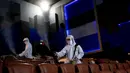 Karyawan menyemprotkan disinfektan sebagai tindakan pencegahan terhadap Covid-19 di bioskop Paragon Cineplex di Bangkok, Thailand, Senin (1/6/2020). (AP Photo/Sakchai Lalit)