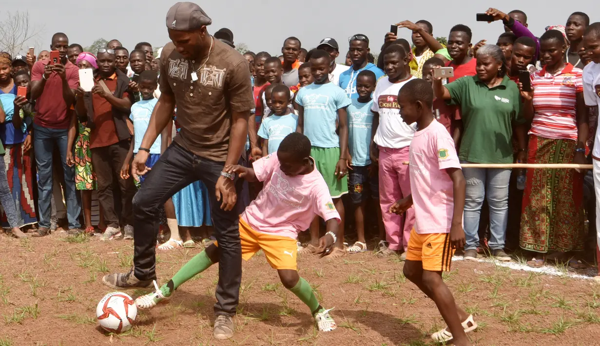 Selain membuka sekolah Drogba juga bermain sepak bola dengan anak-anak di Onahio, Pokou-Kouamekro, Pantai Gading, (20/1/2018).  Drogba menjadi salah satu sponsor utama untuk sekolah tersebut. (AFP/Sia Kambou)