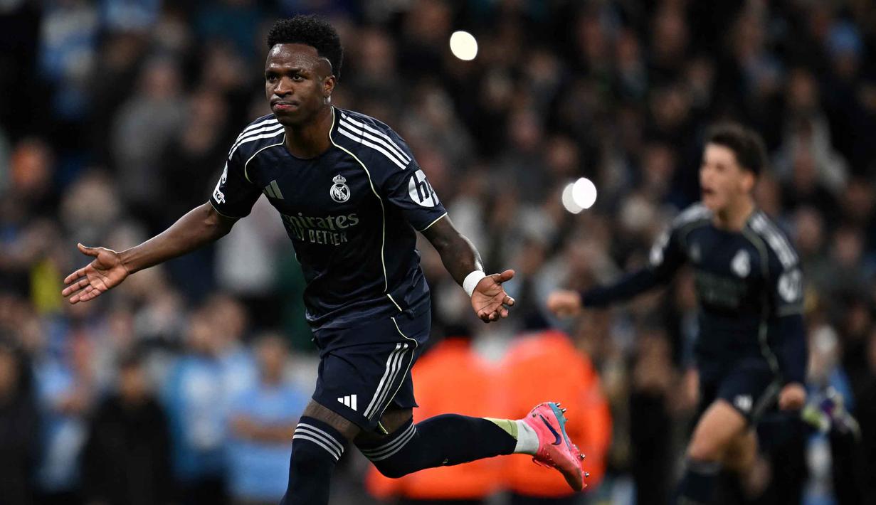 Gol penentu kemenangan Real Madrid tercipta pada menit ke-90+3 setelah Aurelien Tchouameni mengirim umpan silang akurat dari sisi kanan yang disambut Vinicius Junior. Real Madrid unggul 2-1. Tampak dalam foto, penyerang Real Madrid asal Brasil, Vinicius Junior, merayakan golnya pada pertandingan leg kedua 16 besar Liga Champions 2025/2026 melawan Manchester City di Etihad Stadium, barat laut Inggris, pada Selasa 17 Maret 2026 waktu setempat atau Rabu (18/3) dini hari WIB. (Paul ELLIS/AFP)