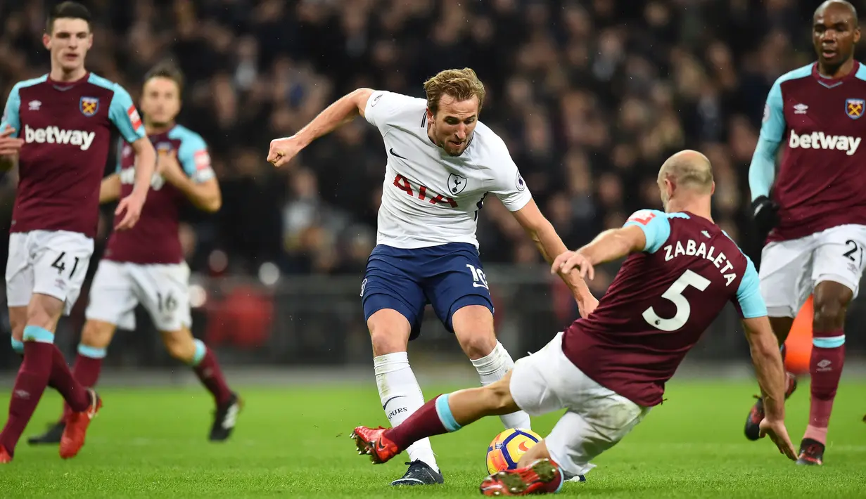 Bek West Ham United, Pablo Zabaleta menghalau tendangan striker Tottenham Hotspur, Harry Kane dalam lanjutan pertandingan Premier League di Stadion Wembley, Jumat (5/1). Tottenham Hotspur ditahan imbang tamunya West Ham 1-1. (Glyn KIRK / AFP)