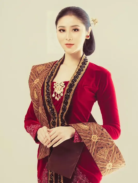 Tampil dengan kebaya Jawa berwarna merah, gaya Putu Ayu disebut netizen begitu memesona. Ia pun memilih menggunakan sanggul sederhana serta memakai selendangt batik. (Liputan6.com/IG/@ayusarasw)