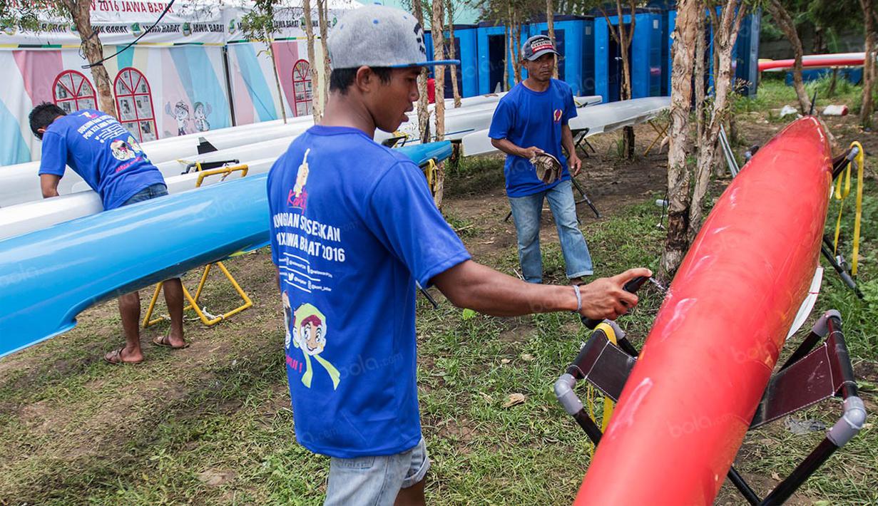 Official tim Jawa Barat mempersiapkan perahu untuk dipergunakan dalam laga final. Raihan 12 emas melampaui target awal yang hanya lima medali emas. (Bola.com/Vitalis Yogi Trisna)
