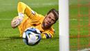 Kiper Timnas Liechtenstein, Benjamin Buchel melakukan penyelamatan saat menghadapi Portugal pada laga lanjutan Grup J Kualifikasi Euro 2024 di Rheinpark Stadium, Vaduz, Jumat (17/11/2023) dini hari WIB. (AFP/Sebastien Bozon)