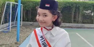 Bilqis pun mengenakan peci hitam dengan lambang bendera merah putih di atas rambut pendek ikalnya. Ia tampak mengenakan anting-anting minimalis. [@ayutingting92]