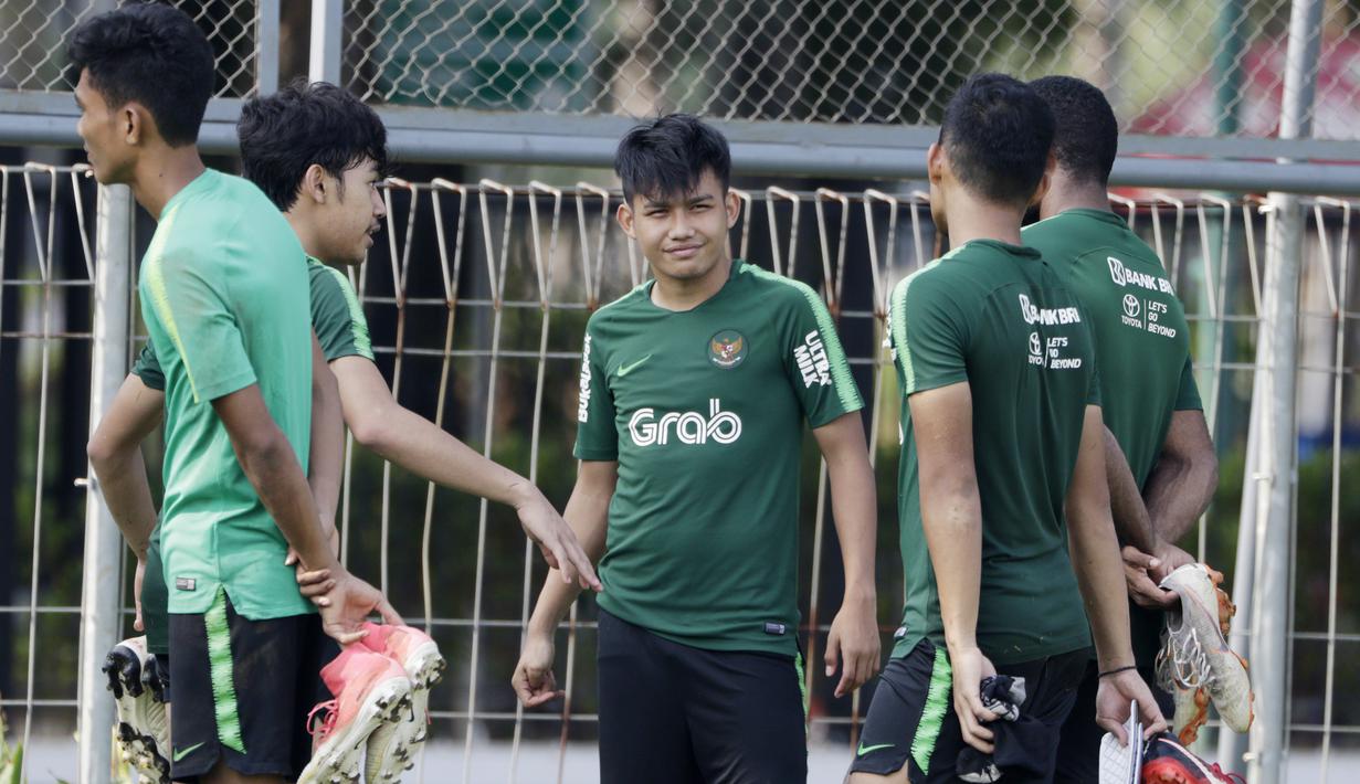Pemain Timnas Indonesia U-22, Witan Sulaeman, berbincang dengan rekannya saat latihan di Lapangan ABC, Senayan, Jakarta, Sabtu (12/1). Witan menjadi pemain termuda dalam pemusatan latihan dan seleksi Timnas Indonesia U-22 dengan usia 17 tahun. (Bola.com/M