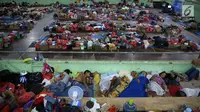 Sejumlah pengungsi Gunung Agung berisitirahat di lokasi pengungsian GOR Swecapura, Klungkung, Bali, Minggu (3/12). Pengungsi Gunung Agung yang berada di Kabupaten Klungkung terus bertambah dengan total 9.304 jiwa. (Liputan6.com/Immanuel Antonius)