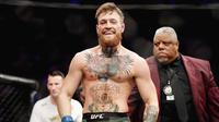 Conor Mcgregor - Forbes menempatkan McGregor sebagai atlet berpenghasilan tertinggi pada tahun 2021. Atlet UFC ini menghasilkan 8,6 juta dollar atau setara Rp121,1 miliar setiap menitnya. (AFP/Harry How)