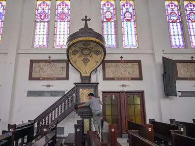 Seorang pekerja membersihkan mimbar di Katedral Hati Kudus Yesus, yang dikenal secara lokal sebagai gereja "Hati Kudus Yesus", selama persiapan Misa Natal di Surabaya, Jawa Timur, pada Selasa 23 Desember 2025. Jelang Misa Natal 2025, Katedral Hati Kudus Yesus atau yang dikenal secara lokal sebagai Gereja Katolik Hati Kudus Yesus di Surabaya, Jawa Timur, telah melakukan berbagai persiapan. (JUNI KRISWANTO/AFP)