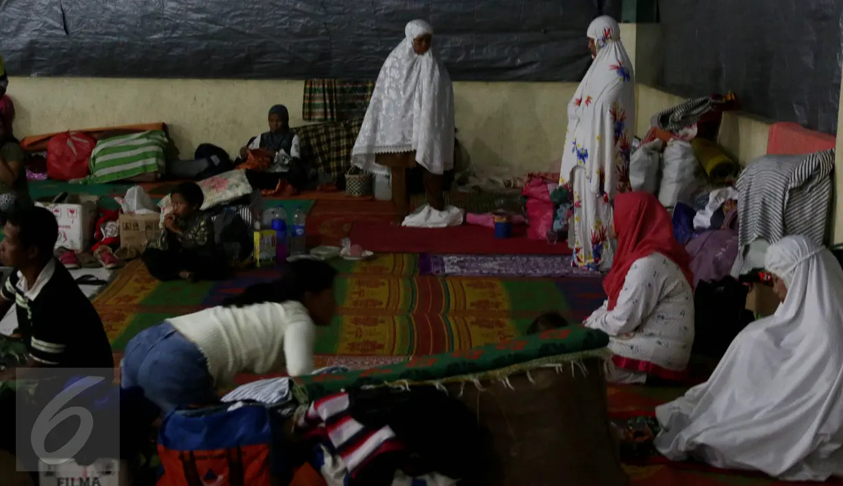 Sejumlah pengungsi terlihat Salat Magrib di tempat pengungsian letusan Gunung Sinabung, Medan, Sabtu (4/7/2015). Pengungsi yang muslim tetap menjalankan puasa dengan menu sahur dan berbuka seadanya. (Liputan6.com/JohanTallo)