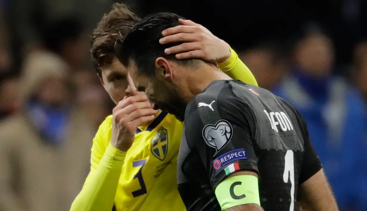 Pemain Swedia, Victor Lindelof mengibur kiper Italia, Gianluigi Buffon di penghujung partai playoff Piala Dunia 2018 di Stadion San Siro, Selasa (14/11). Italia untuk kali pertama sejak 1958, gagal tampil di Piala Dunia. (AP/Luca Bruno)