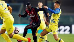 Penyerang AC Milan, M'Baye Niang, melewati hadangan pemain Chievo pada laga Serie A di Stadion Bentegodi, Verona, Minggu (16/10/2016). Milan menang 3-1 atas Chievo. (Reuters/Alessandro Garofalo)