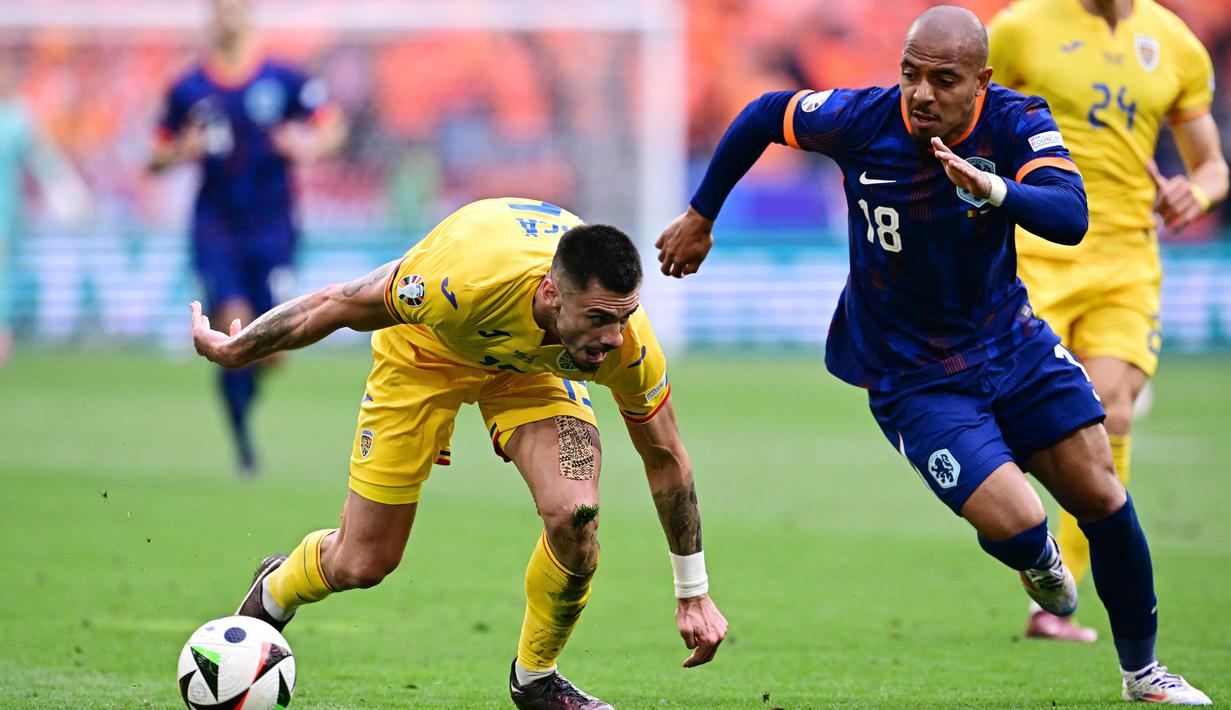Pemain Belanda, Donyell Malen, berusaha melewati pemain Rumania, Denis Dragus, pada babak 16 besar Euro 2024 di Fussball Arena, Munchen, Selasa (2/7/2024). (AFP/Tobias Schwarz)