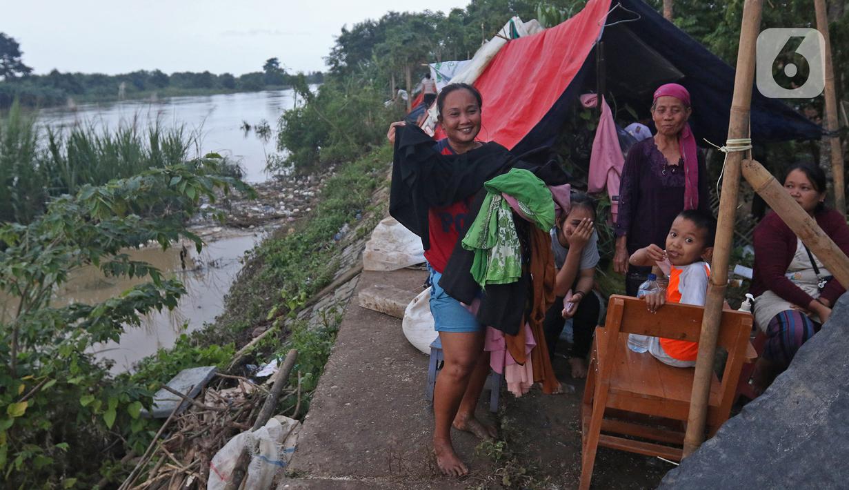 Warga mengungsi di tenda di bantaran sungai Citarum Desa Sumber Urip Pebayuran, Senin (22/2/2021). Sudah tiga hari warga bertahan di tenda pengungsian dikarenakan banjir luapan sungai Citarum yang merendam permukiman warga kampung Babakan Banten Pebayuran. (Liputan6.com/Herman Zakharia)