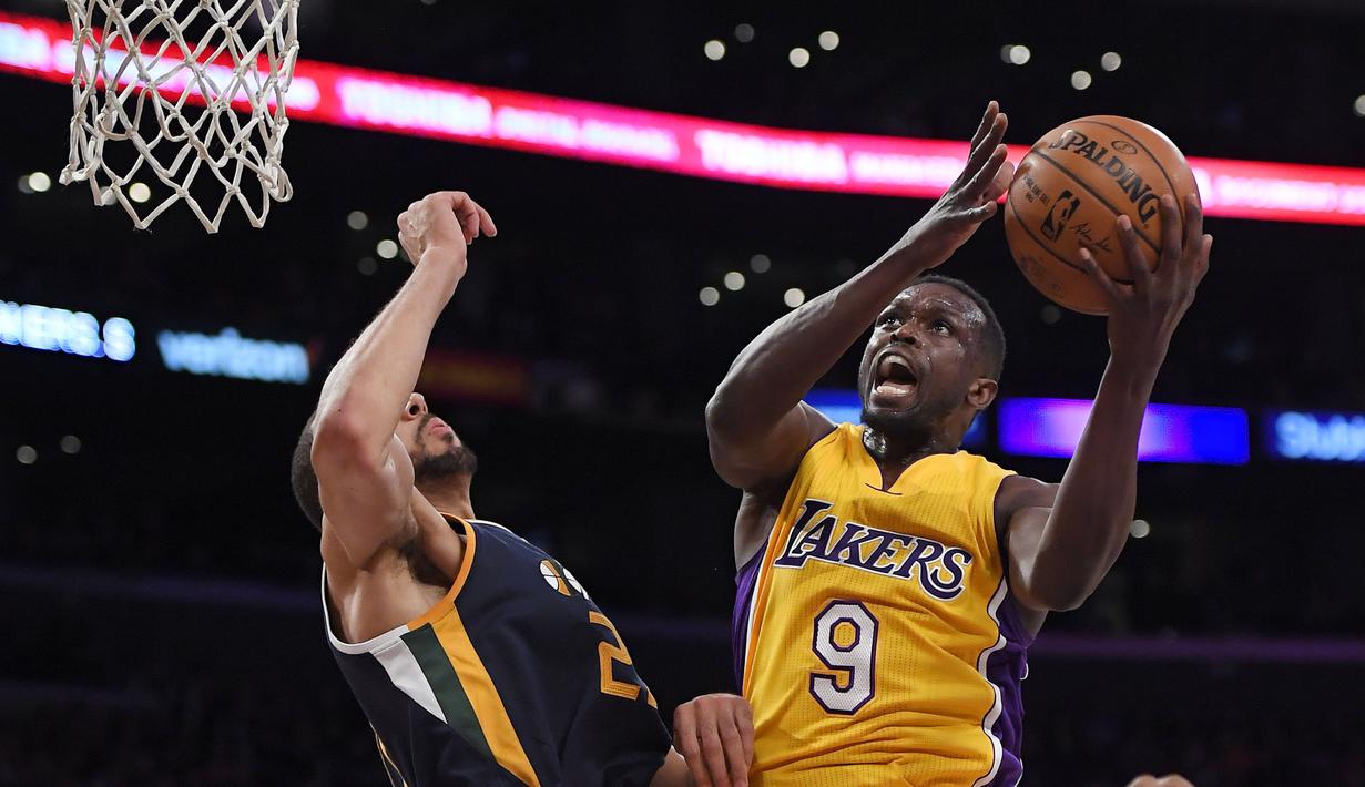 Aksi pemain Lakers, Luol Deng, (kanan) mmecoba memasukan bola saat dihadang pemain Utah Jazz, Rudy Gobert pada laga NBA basketball game di Los Angeles, (27/12/2016).  (AP/Mark J. Terrill)