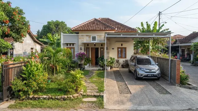 Desain rumah sederhana dengan taman tapi tetap punya area parkir model dengan carport menyatu