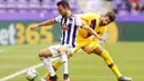 Bek Barcelona, Gerard Pique, berebut bola dengan pemain Real Valladolid, Oscar Plano, pada laga La Liga di Stadion Jose Zorrilla, Sabtu (11/7/2020). Barcelona menang 1-0 atas Real Valladolid. (AP Photo/Manu Fernandez)